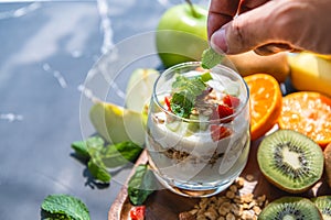 Closeup nutrition yogurt with many fruits on table and chef hand. Food cuisine and drinks concept. Organic dessert theme