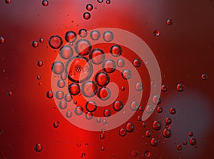 Closeup oil droplets with red light background and shiny