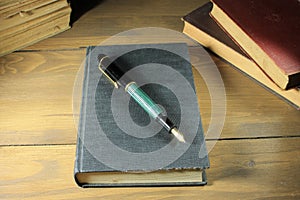 Closeup of old books and fountain pen on top of a book