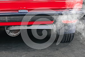 closeup old car rear exhaust pipe with smell smoke carbon monoxide bad air pollution lung disease