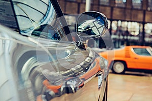 Closeup of old car with silver colored paint on automobile show.