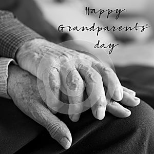 Old man and woman and text happy grandparents day photo