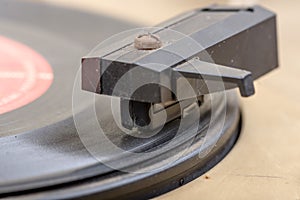 Closeup of old and dusty vinyl record player with arm and needle in focus