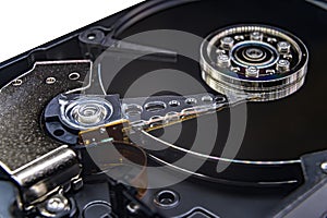 Closeup of an old fashioned, open, mechanical harddisc drive, isolated on a white background