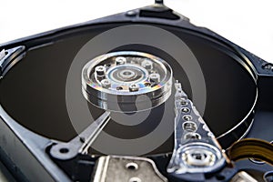 Closeup of an old fashioned, open, mechanical harddisc drive, isolated on a white background