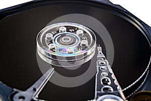 Closeup of an old fashioned, open, mechanical harddisc drive, isolated on a white background