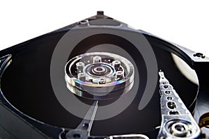 Closeup of an old fashioned, open, mechanical harddisc drive, isolated on a white background