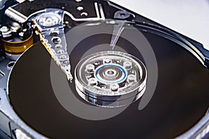 Closeup of an old fashioned, open, mechanical harddisc drive, isolated on a white background