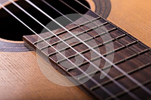 Closeup of old guitar body with sound hole and strings