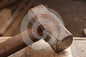 Closeup of an old hammer on wood table