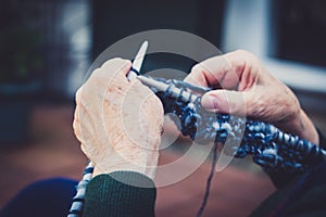 closeup on old lady hands to knitting