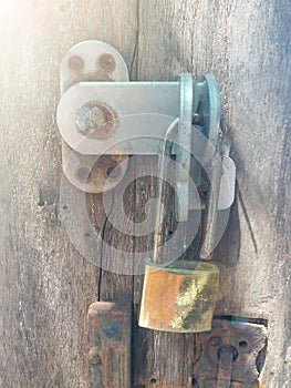 Closeup of old lock the door. Rusty lock on an old wooden vintage gate