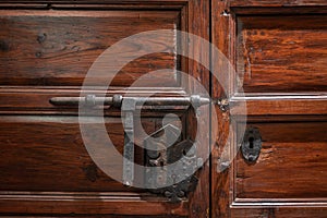 Closeup of an old lock with pin of a wooden door