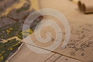 Closeup of old maps laid together on a table, a cartographic background photo