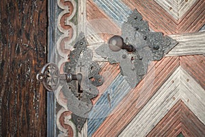 Closeup of old massive metal key in church ancient door