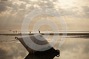 Closeup of an old metal buoy with a german word Surfen (Surfing) on the beach