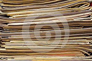 Closeup of old newspapers and magazines, stack, side view