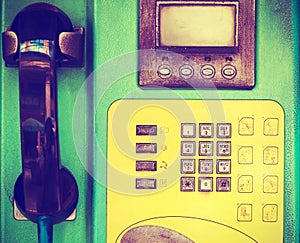 Closeup of old public telephone in phonebooth