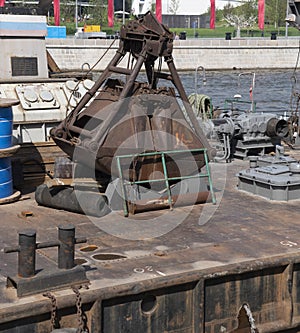 Closeup of an old rusty clamshell bucket from wire ropes and chains