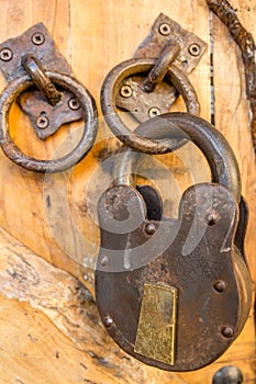 Closeup of an old rusty lock on the wooden door in Montenegro