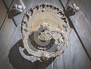 Old rusty door knocker on door