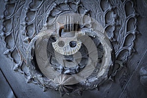 Old rusty door knocker on door