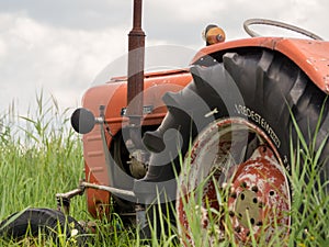 Closeup of old rusty traktor in field