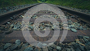 Closeup of old rusty tram rails, grass background