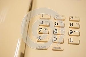 Closeup of old style wired desktop telephone - studio shot