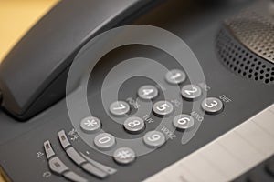 Closeup of old style wired desktop telephone - studio shot