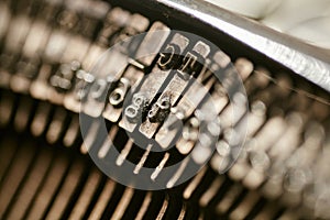 Closeup of old typewriter plates strikers strykers with letters and symbols for typing photo