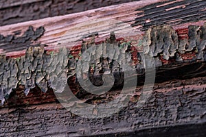 Closeup of an old weathered wooden window with the peeling paint