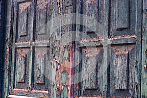 Closeup of an old weathered wooden window with the peeling paint