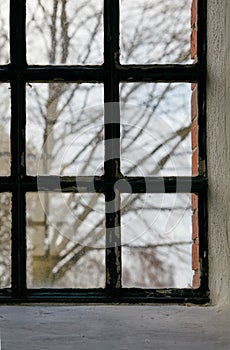 Closeup of an old window. Feeling trapped, scared, depressed and lonely during lockdown. Hiding inside at home