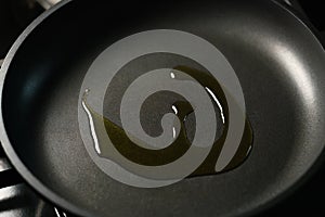 Closeup olive oil in nonstick frying pan