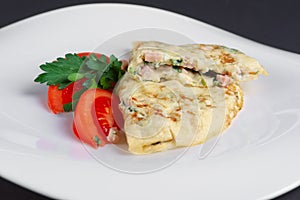 Closeup of omelet with ham and vegetables