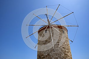 Closeup of One of the Ancient Windmills Against the Blue Sky on Rhodes Harbor