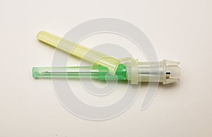 Closeup of one isolated disposable safety injection cannula needle with plastic glide