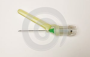 Closeup of one isolated disposable safety injection cannula needle with plastic glide