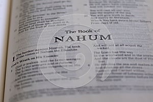 Closeup of an open page of the book of nahum with partly blurred text