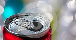 Closeup of the open red soda can with the blurred background on a sunny day