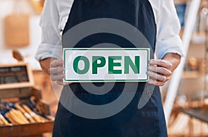 Closeup, open sign or small business woman, hands or retail store for shopping, service or product. Board, welcome and