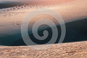 orange nature texture of the sand and dunes rippled surface, top angle view. Desert background. Play of light and shadow