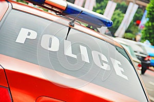 Closeup of the orange police car with a sign POLICE