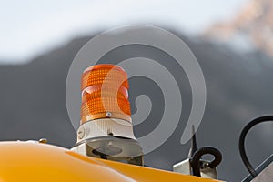 Closeup orange rotating beacon warning light lamp