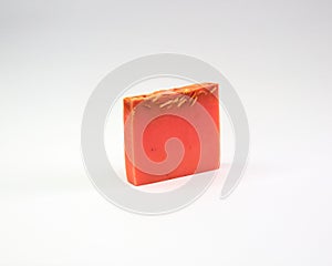 Closeup of an orange-scented soap bar isolated on a white background
