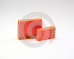 Closeup of orange-scented soap bars isolated on a white background