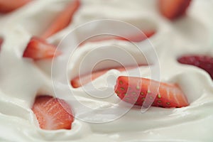 Closeup of organic sliced strawberries in whipped cream