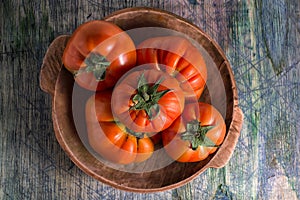 Closeup of organic tomato in wood bowl