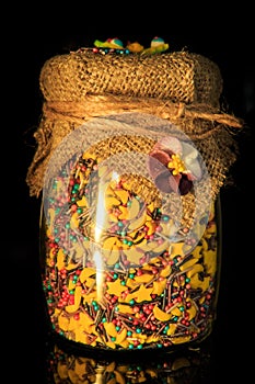closeup originally decorated glass jar with colorful topping